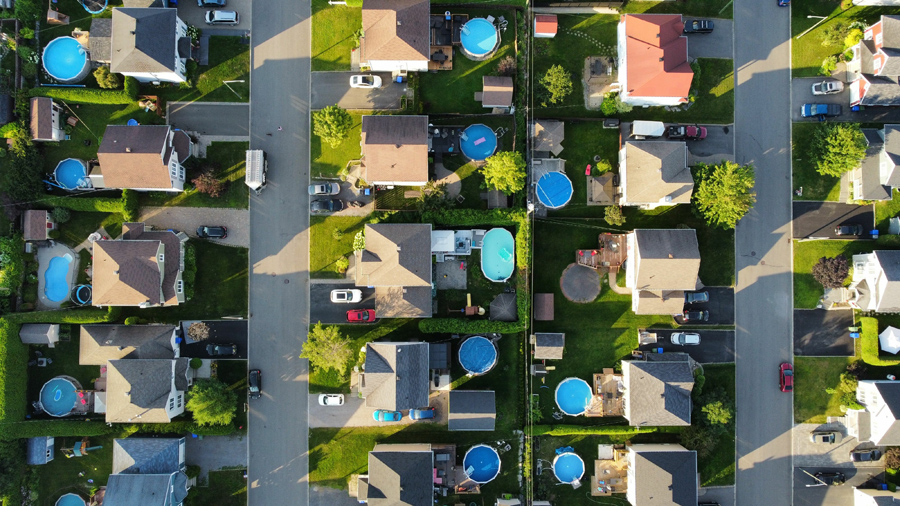 Aerial view of houses with swimming pools